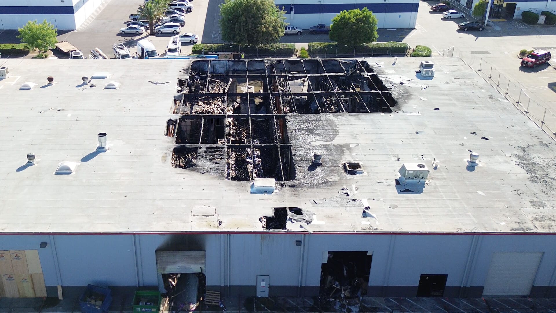 Shot from above of huge warehouse remains after fire