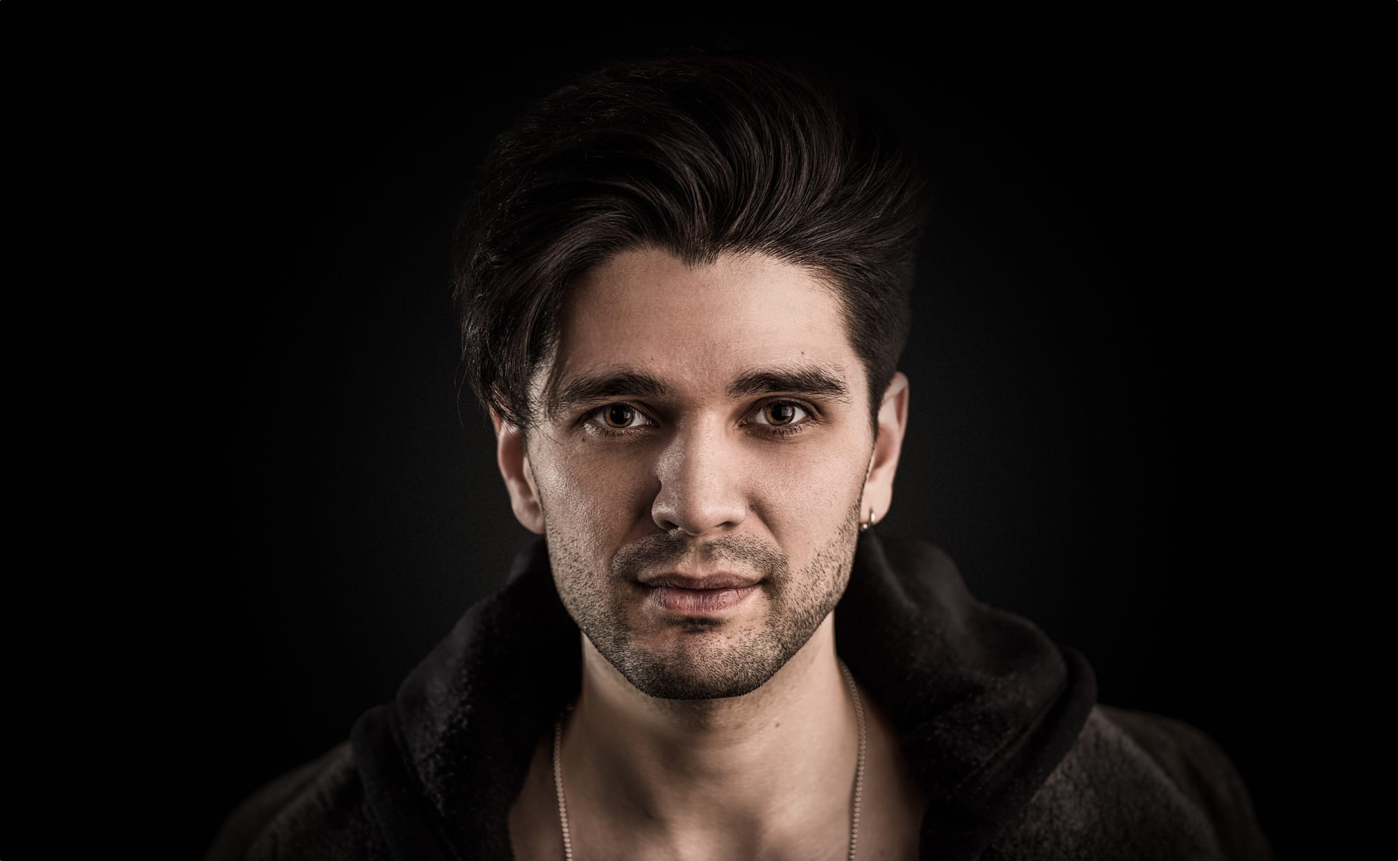 Headshot of London magician Maddox Dixon with black background