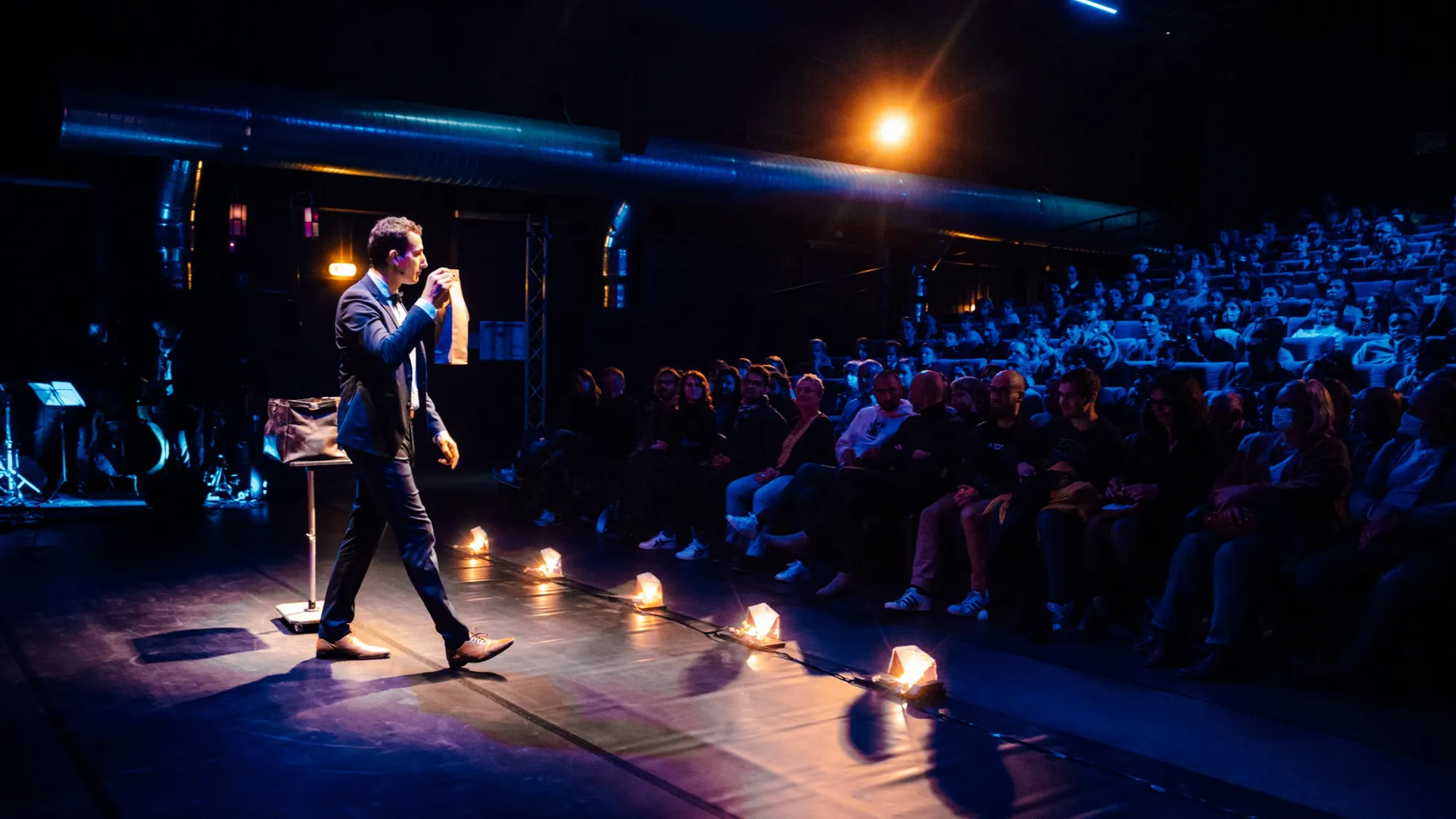 Sofyan Ala performing magic on stage in Lille, Hauts-de-France