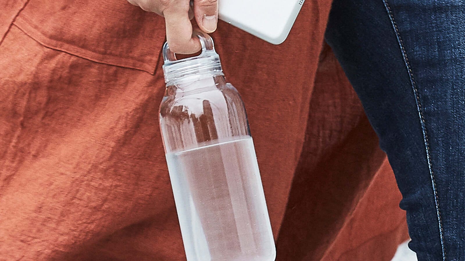 Kino bottle held by walking person