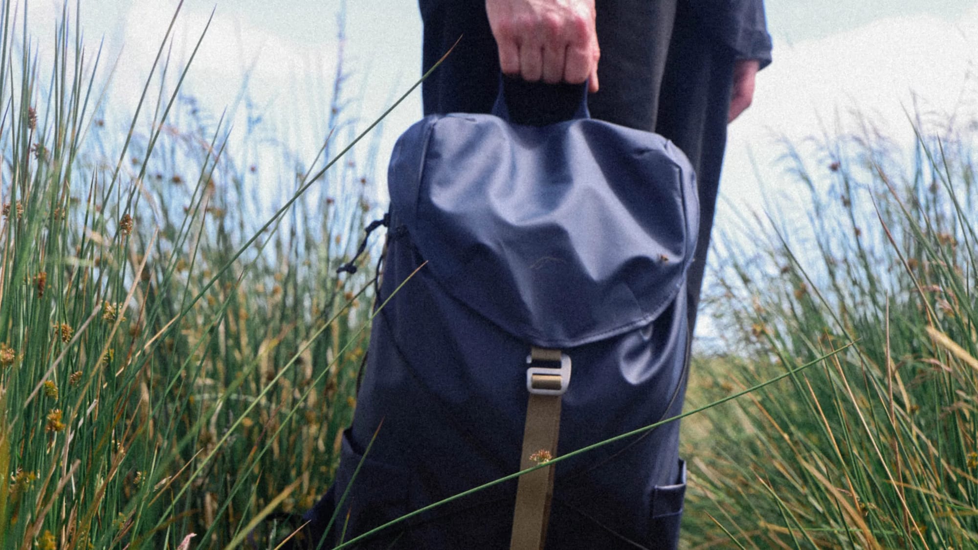 Elliker Backpack held by someone in field