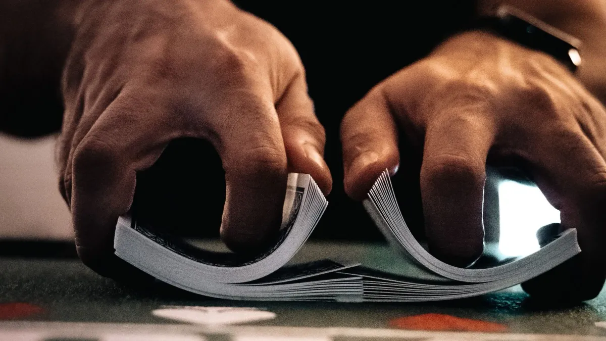 Playing cards getting shuffled together by a magician