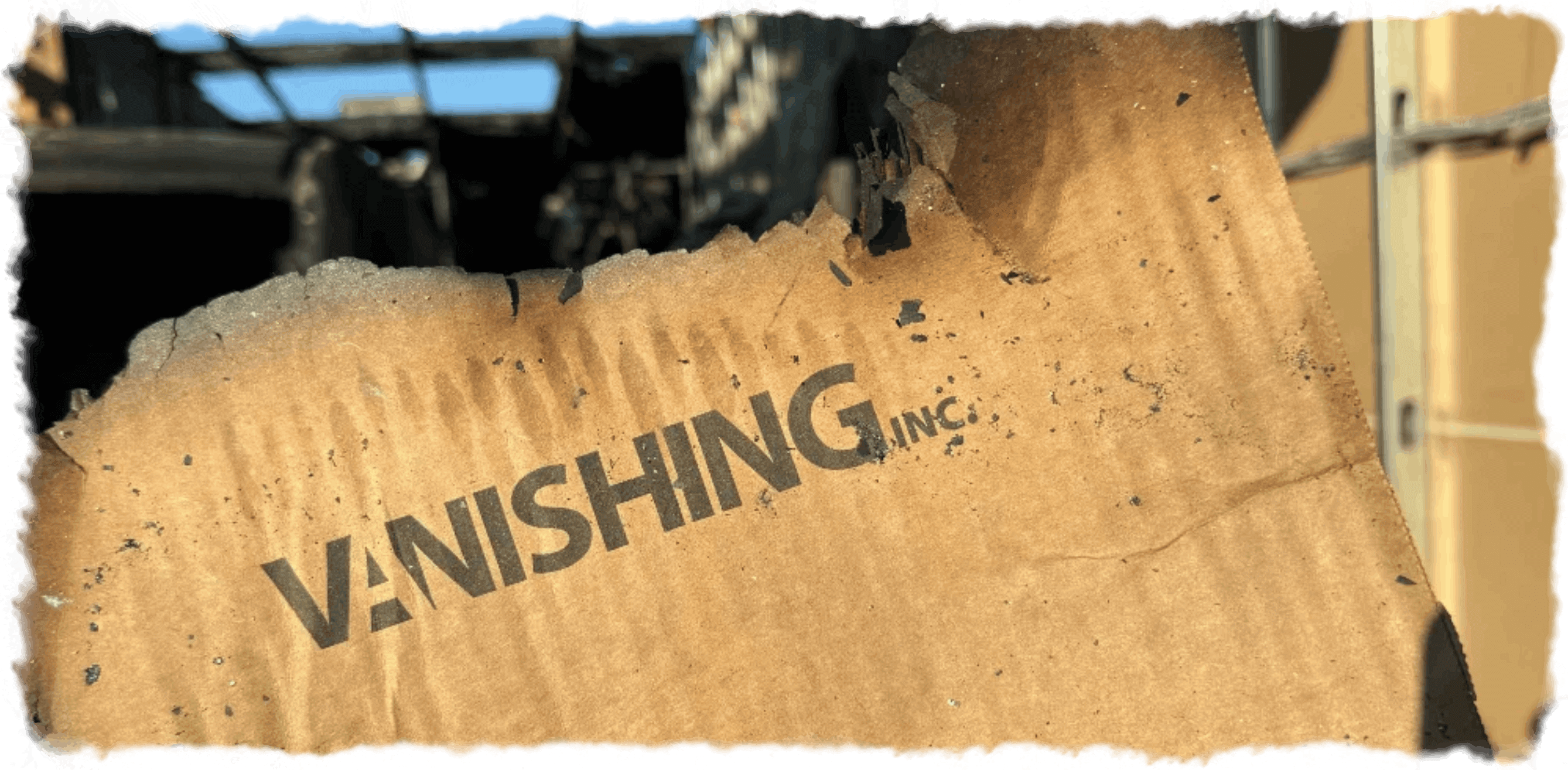 Burned packaging at warehouse fire with Vanishing Inc logo