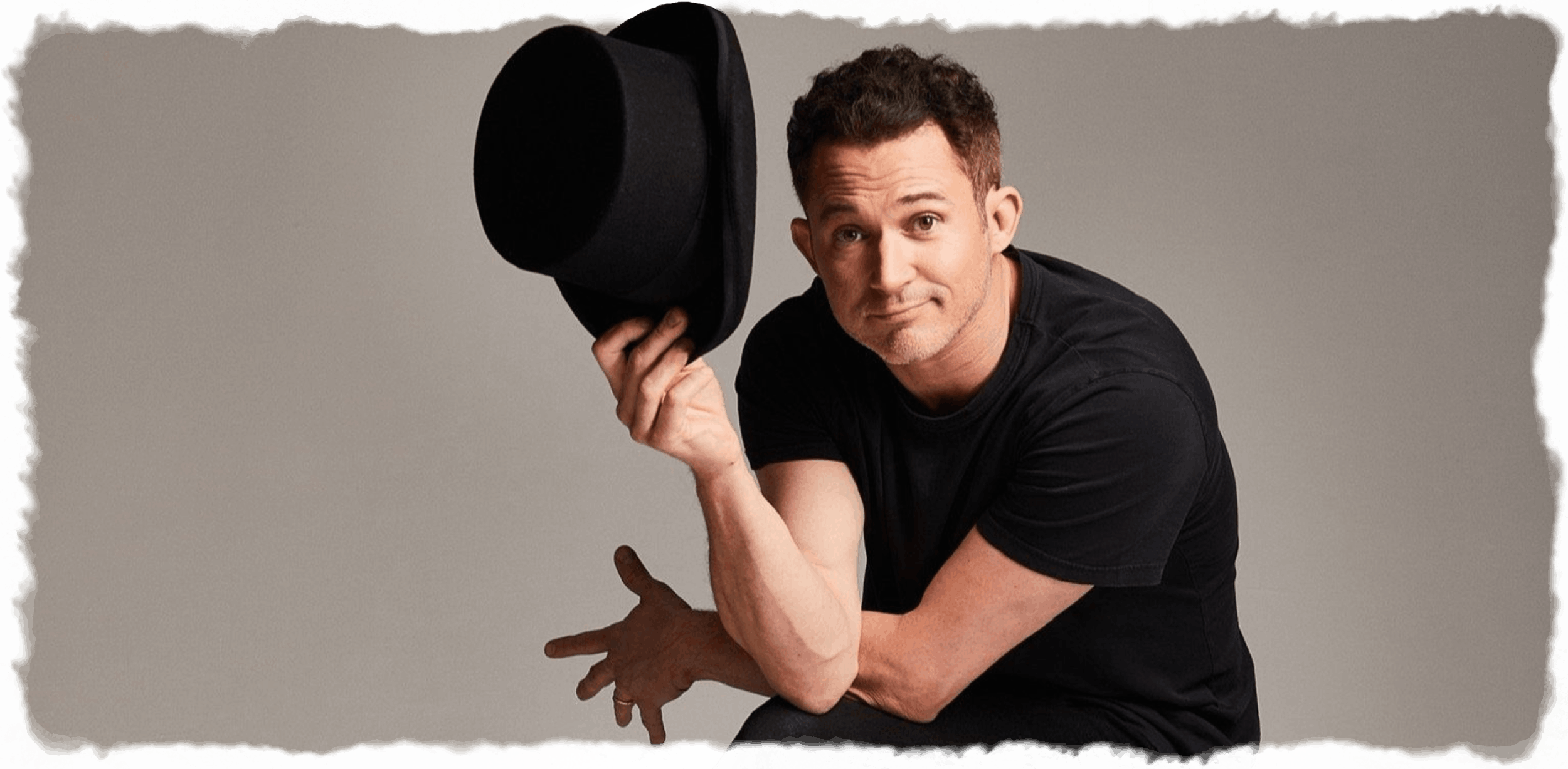 Justin Willman magician holding top hat