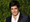 Las Vegas Magician and Illusionist David Copperfield in suit against green hedge