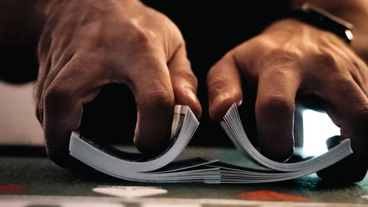 Playing cards getting shuffled together by a magician