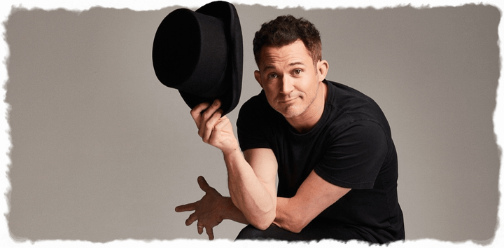 Justin Willman magician holding top hat