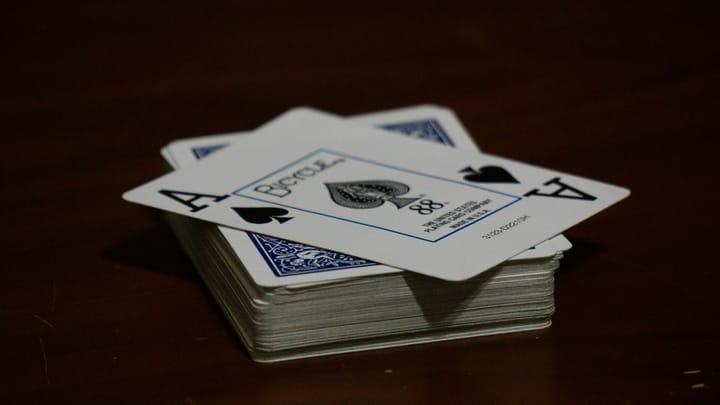 Playing cards on table with an ace of spades 