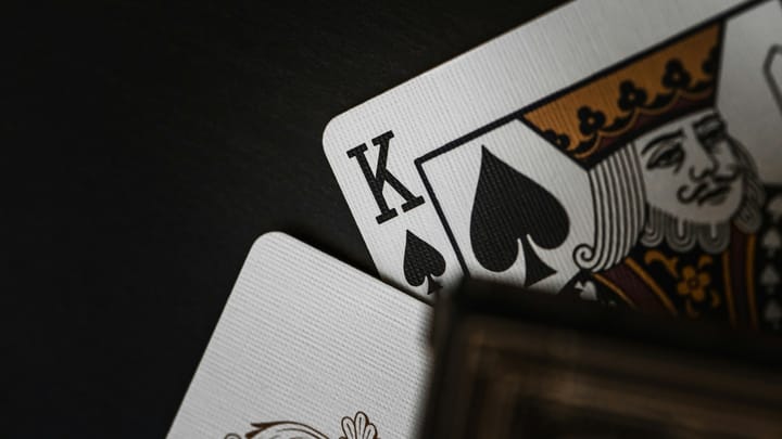 King of spades card against black background